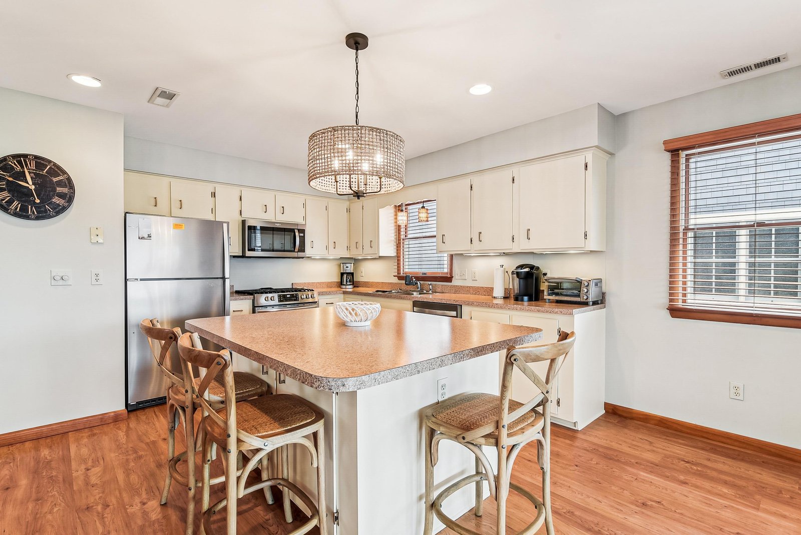 Your fully equipped kitchen features a center island with breakfast bar seating, granite countertops, and stainless steel appliances—perfect for preparing meals and gathering with loved ones.
