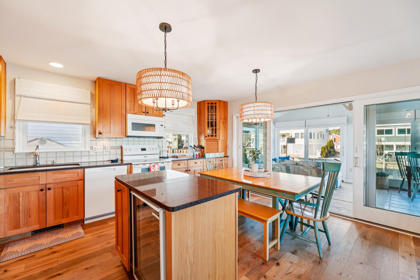 Picture yourself preparing meals in this bright, fully equipped kitchen with coastal charm. The island and dining nook invite you to gather with loved ones while enjoying natural light streaming through large windows.