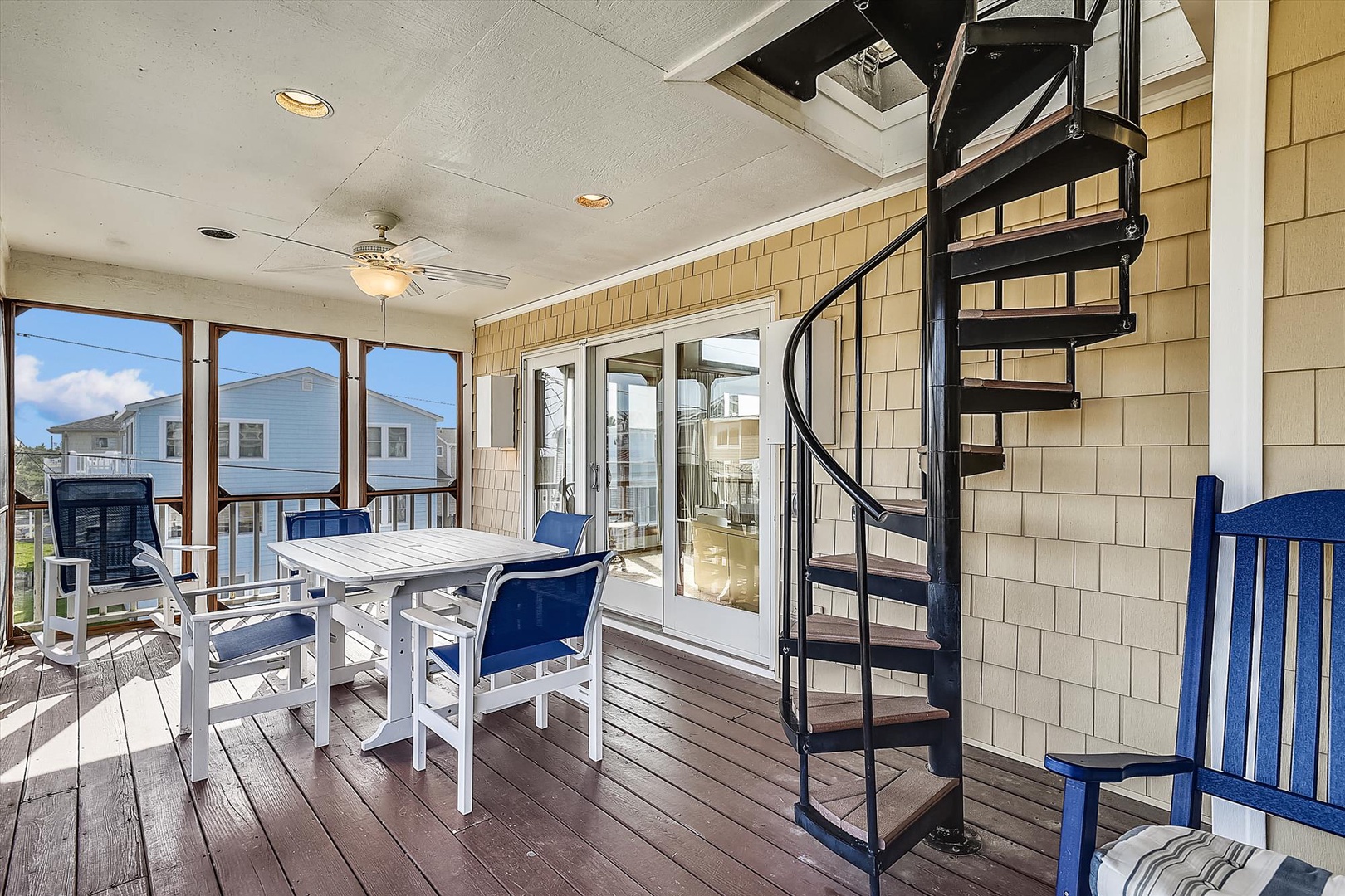 Step out onto this covered patio to enjoy coastal breezes, scenic views, and outdoor dining. A spiral staircase offers easy access to the upper deck.