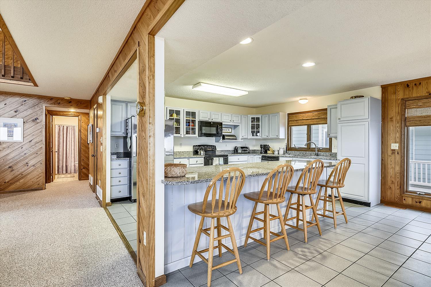 Cook up your favorite meals in your bright, fully equipped kitchen, complete with granite counters, modern appliances, and a spacious island with bar seating for relaxed dining and conversation.