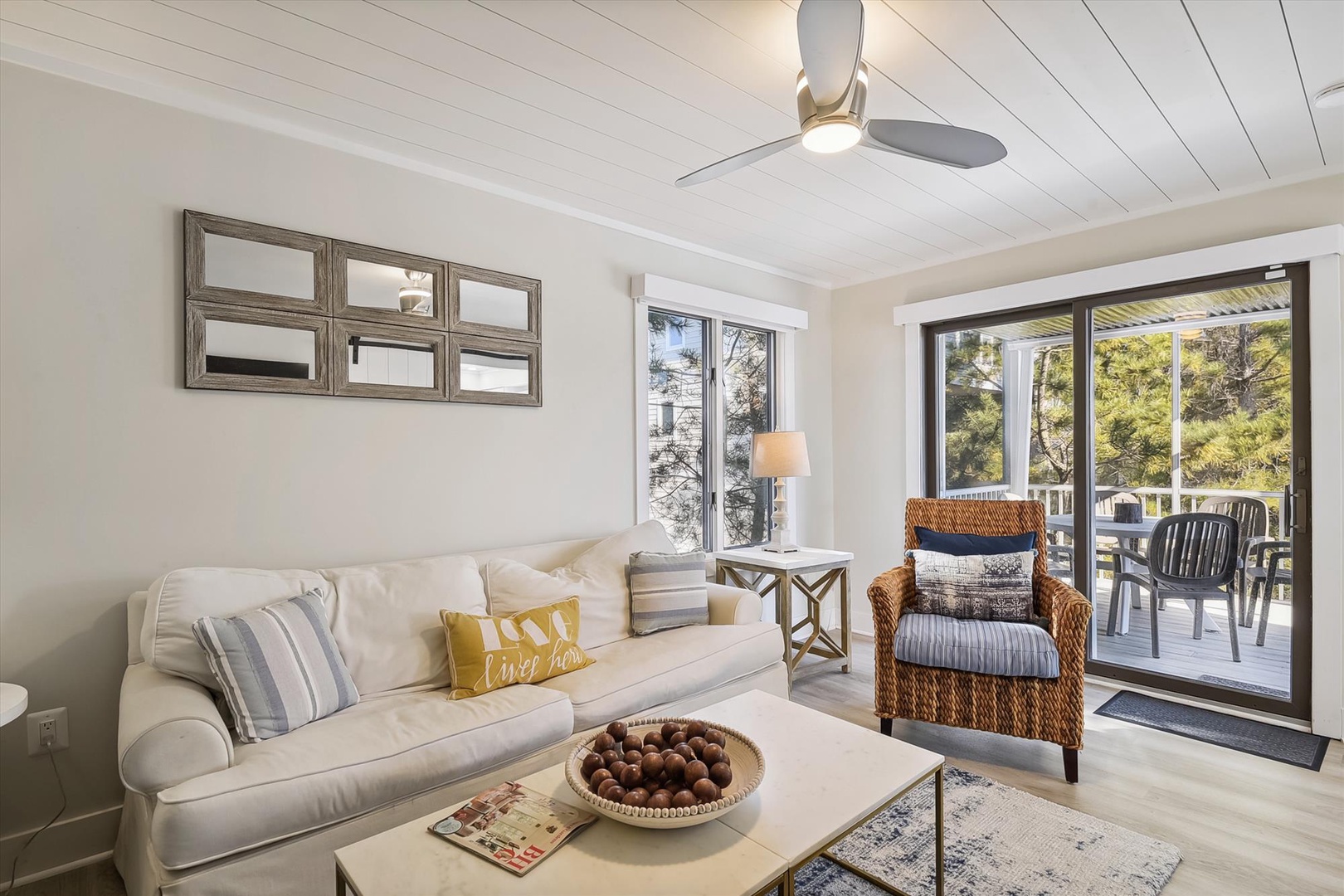 Settle into your bright, coastal-inspired living space where fresh breezes flow through glass doors to your private patio. Soft natural light and beach-cottage charm create the perfect retreat for unwinding after exploring the area.