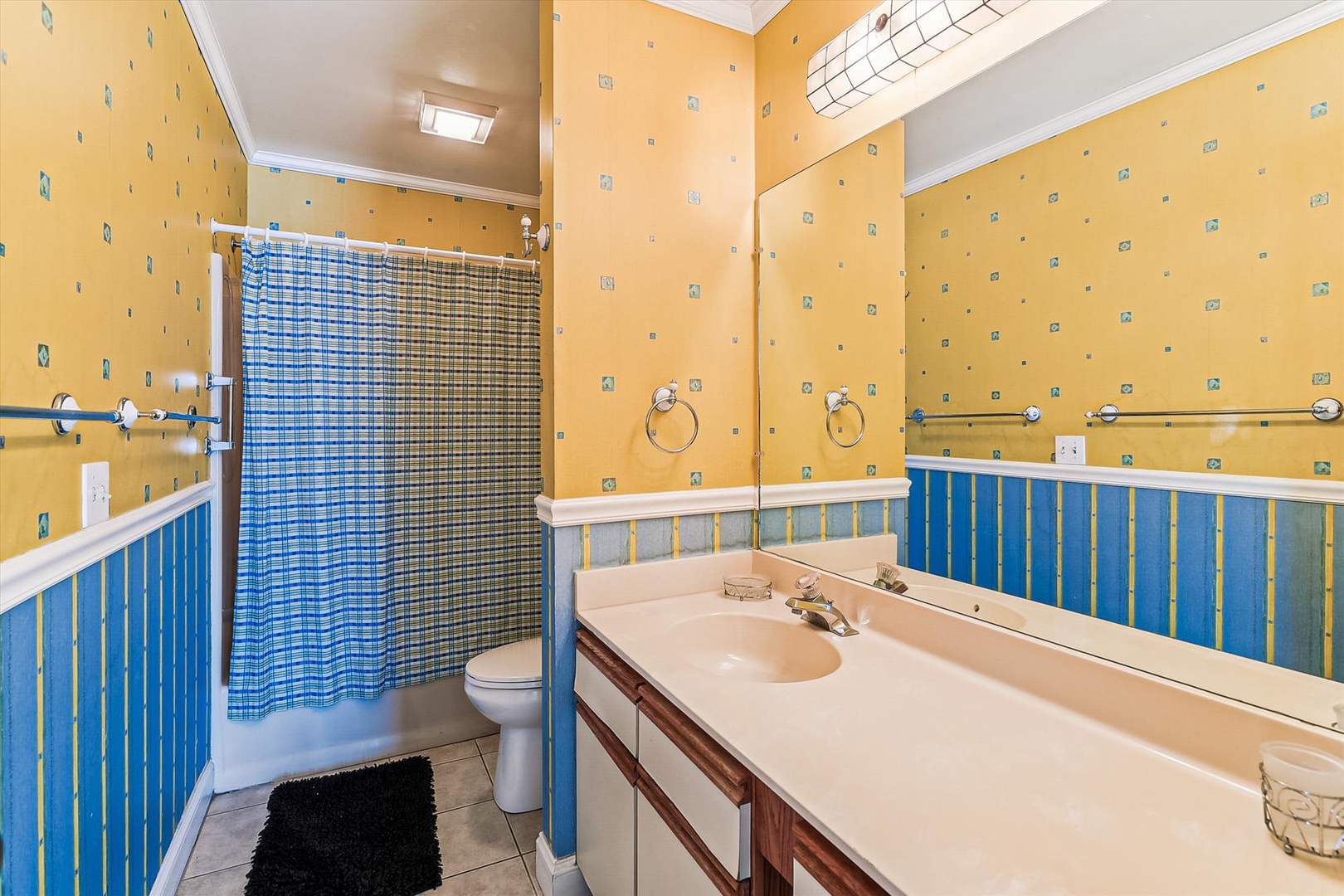 Your cheerful bathroom features bright tile, a spacious vanity, and a refreshing shower-tub combo—perfect for unwinding after a day of adventure.