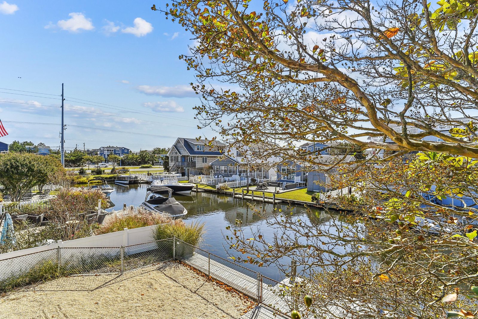 Charming waterfront community with private boat docks and autumn foliage. The property sits along a tranquil canal, offering easy access to coastal living and seasonal beauty.