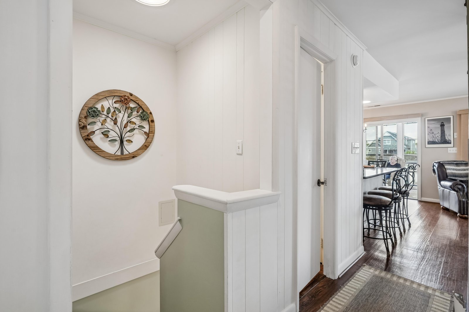 Bright hallway welcomes you with charming tree of life décor, connecting your private spaces to a cozy dining and living area perfect for relaxing after your adventures.