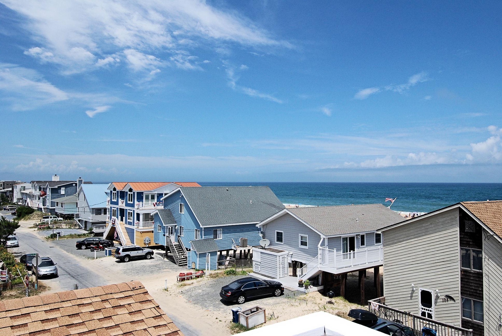 Coastal neighborhood featuring beach houses with direct ocean access, offering a relaxed seaside atmosphere near sandy shores and clear blue waters.
