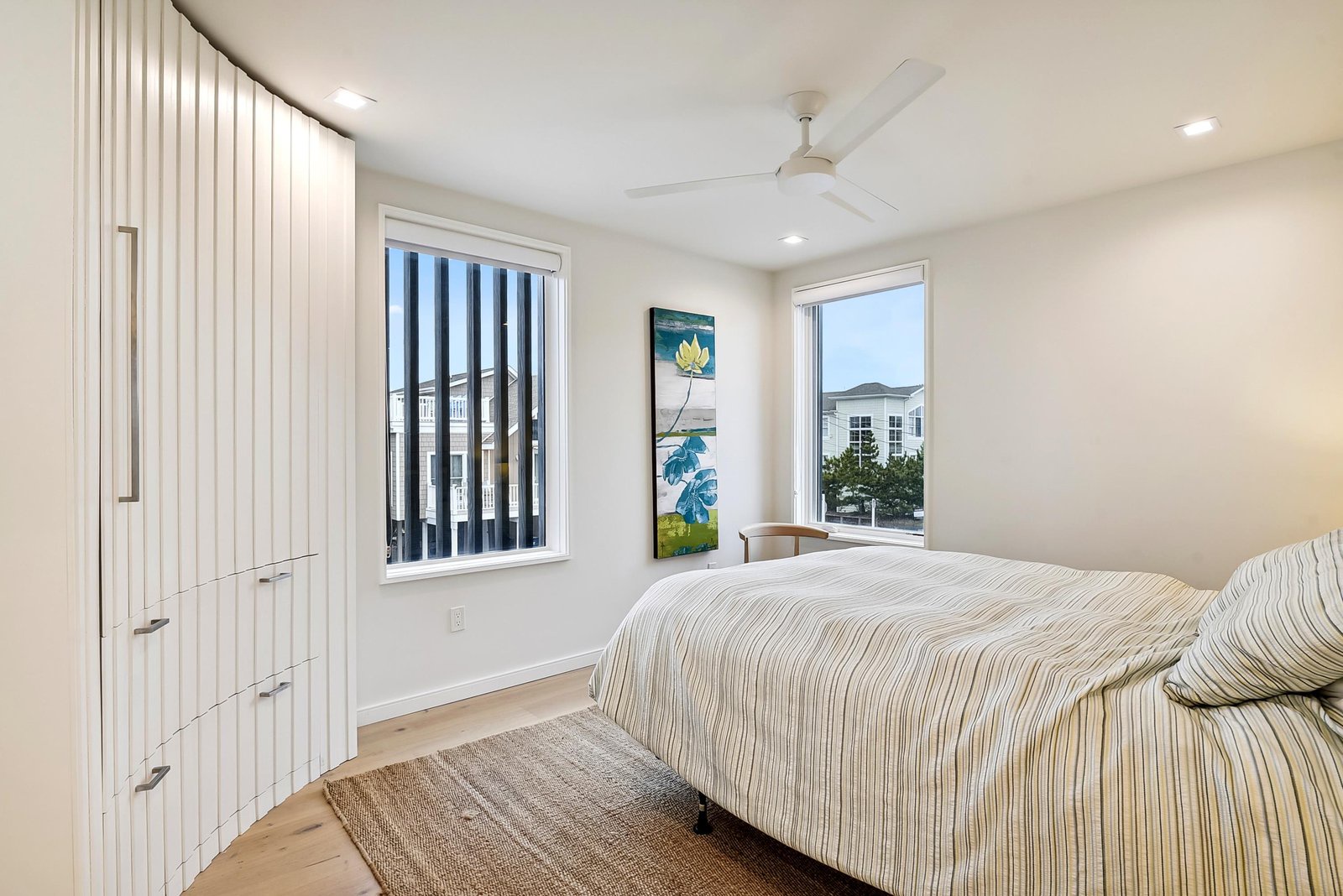 Unwind in this bright bedroom with natural light pouring through dual windows and the ceiling fan keeping you cool.