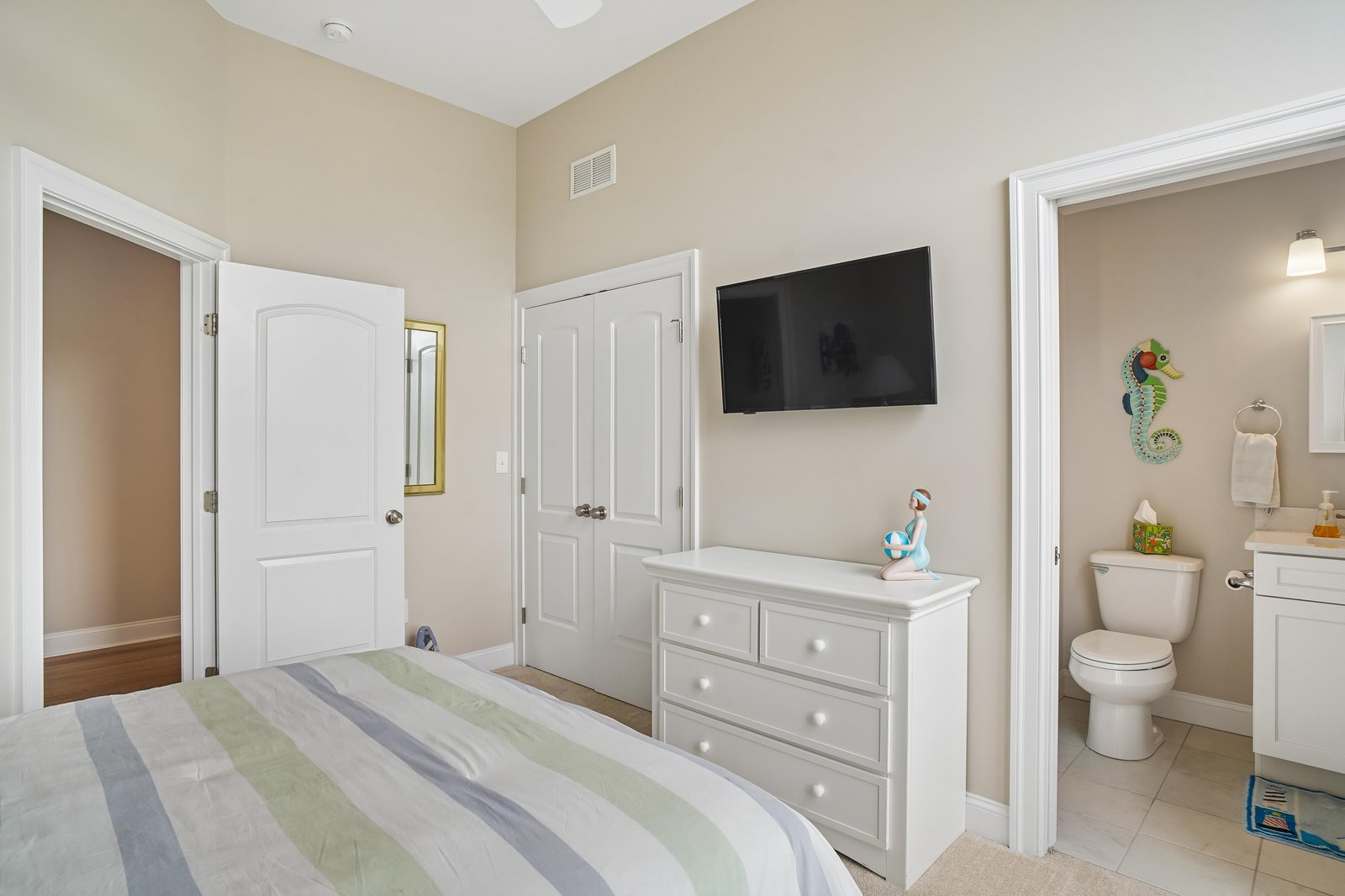 Your light-filled bedroom offers a peaceful retreat, with soft linens, a flat-screen TV for unwinding, and an ensuite bathroom just steps away for your convenience.