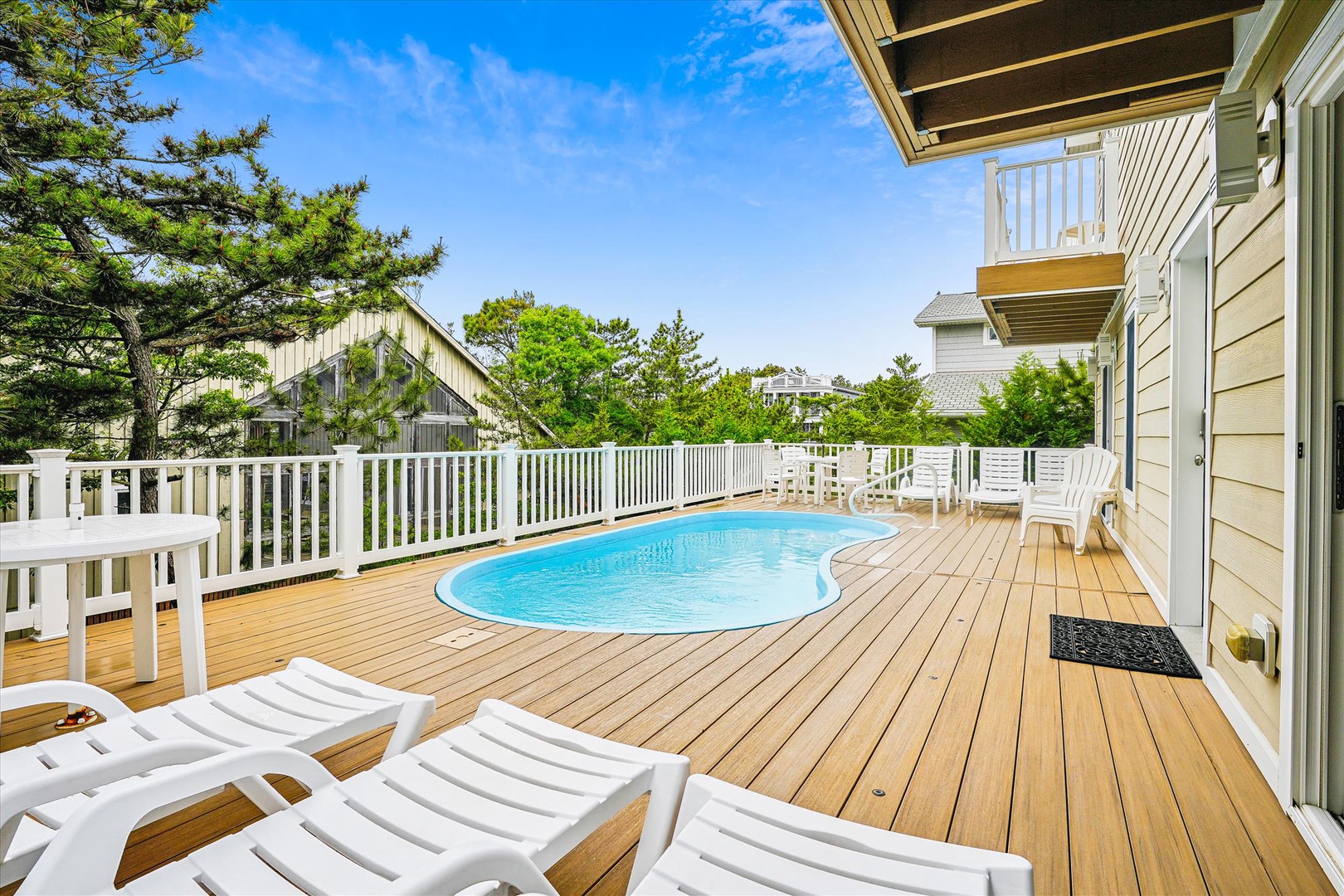 Your private deck awaits with a sparkling pool, sunny loungers, and lush treetop views—perfect for relaxing mornings and peaceful evenings under open skies.