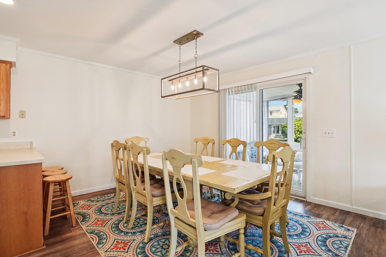 Gather around this spacious dining table with room for everyone, bathed in natural light and just steps from your own outdoor space.