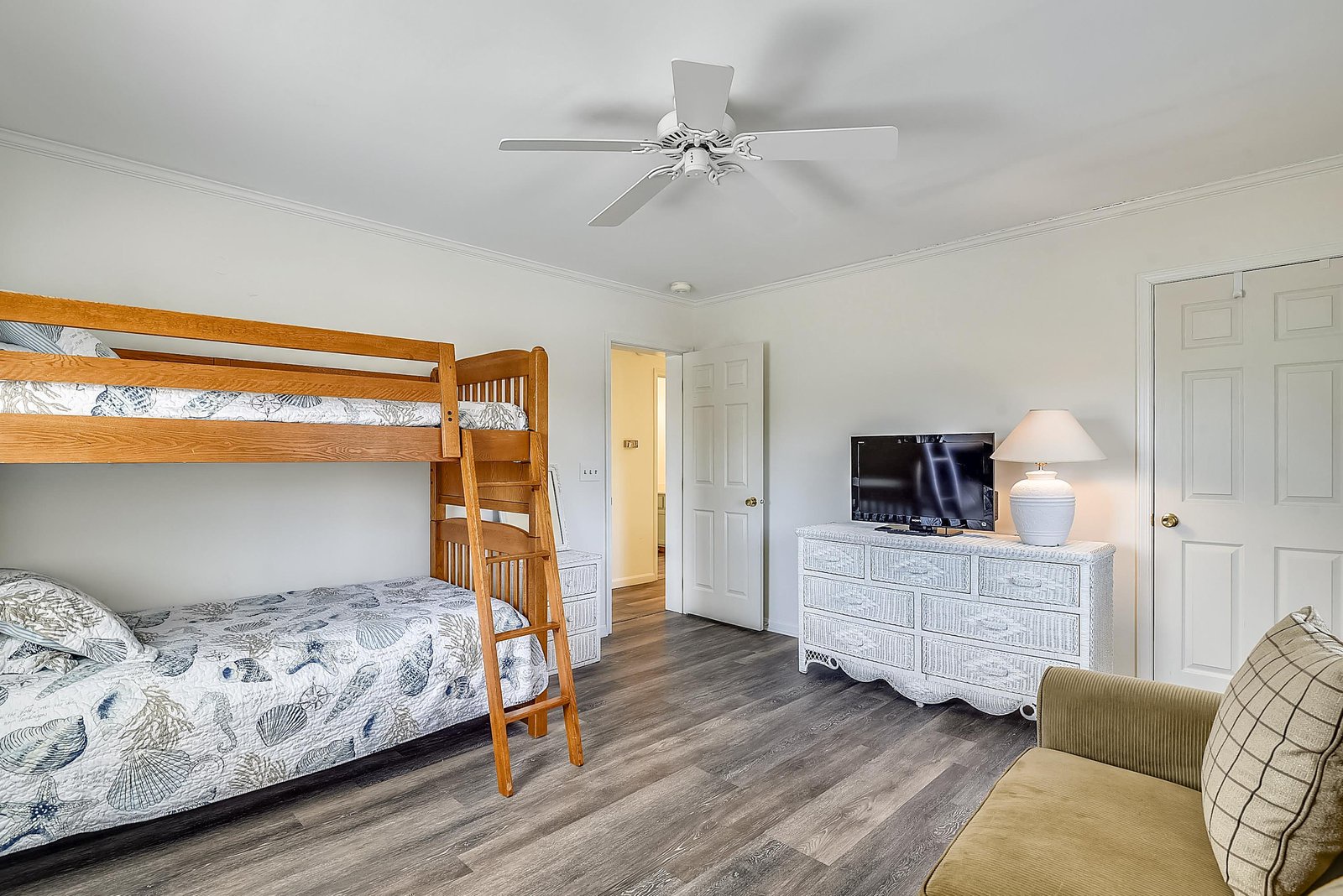 Your bedroom offers flexible sleeping arrangements with a bunk bed and additional bed, along with a TV and dresser for comfortable unpacking.
