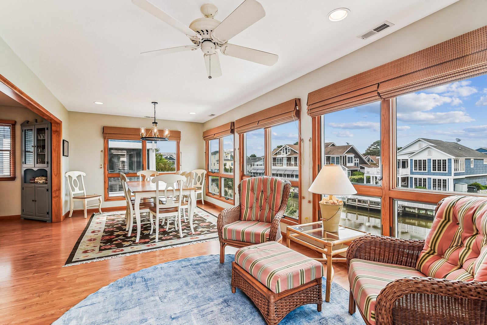 Settle into this sunlit space, where waterfront views and coastal breezes drift through your windows. Relax on wicker furnishings or gather at the dining table for easy, breezy vacation living.