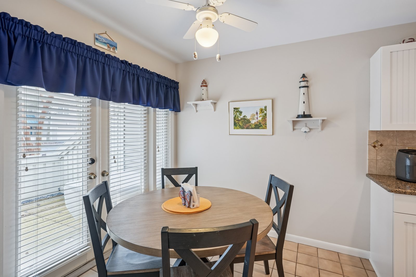 Gather around this charming round dining table where nautical touches create a coastal atmosphere perfect for your morning coffee or evening meals.
