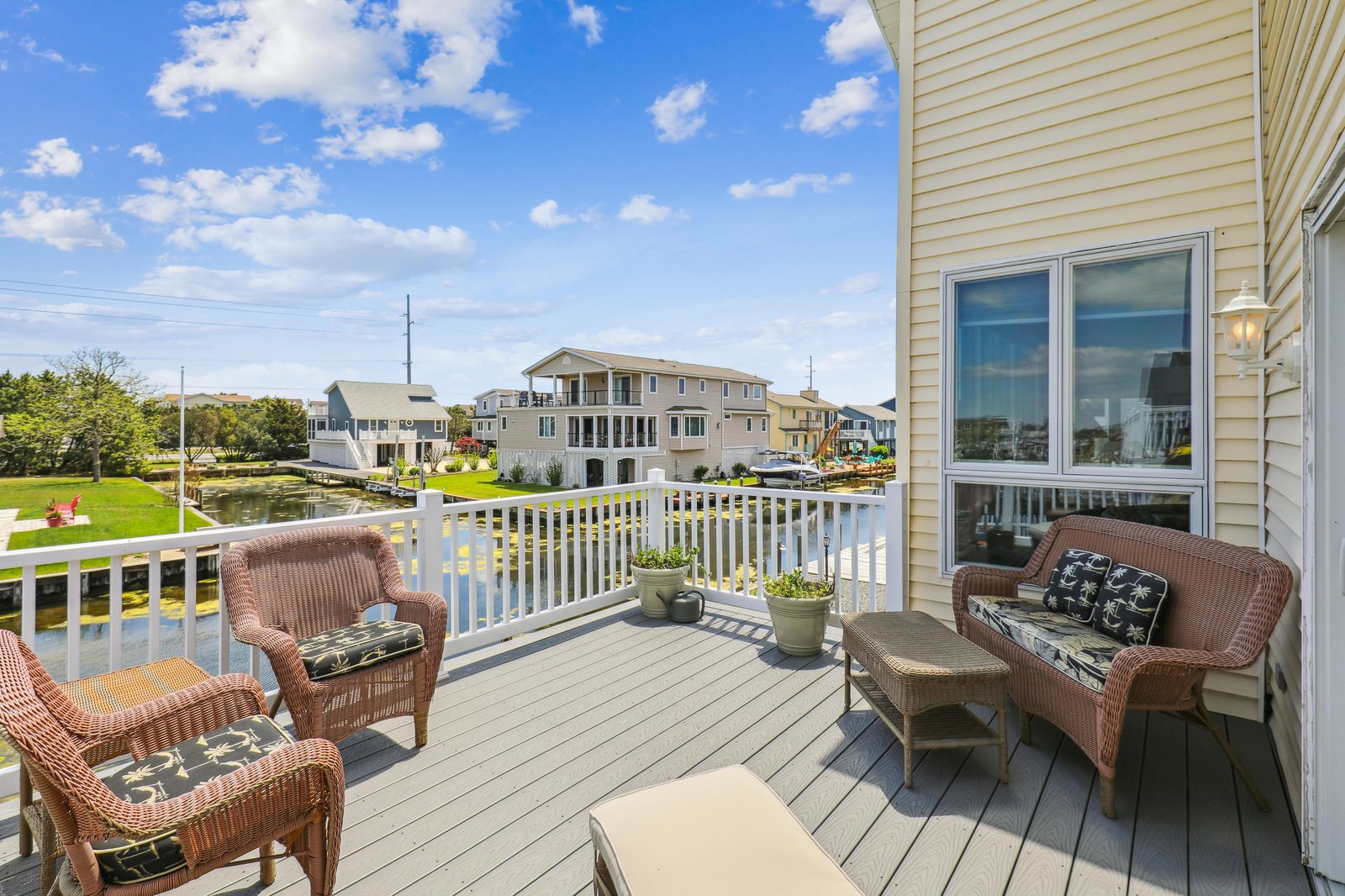 Waterfront homes dot the shoreline of this peaceful canal community, visible from your private balcony overlooking tranquil waterways and manicured lawns.