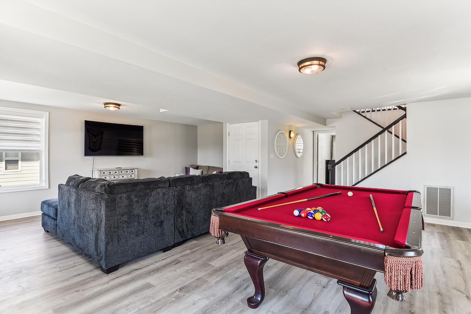 Challenge friends to a game on the stunning billiard table, then sink into plush seating to watch your favorite shows. This inviting entertainment space offers endless ways to unwind and create memories together.