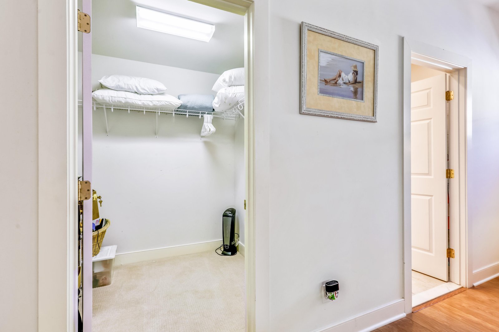 A walk-in closet with built-in shelving and natural light from a skylight above—your belongings stay organized and easy to access throughout your stay.