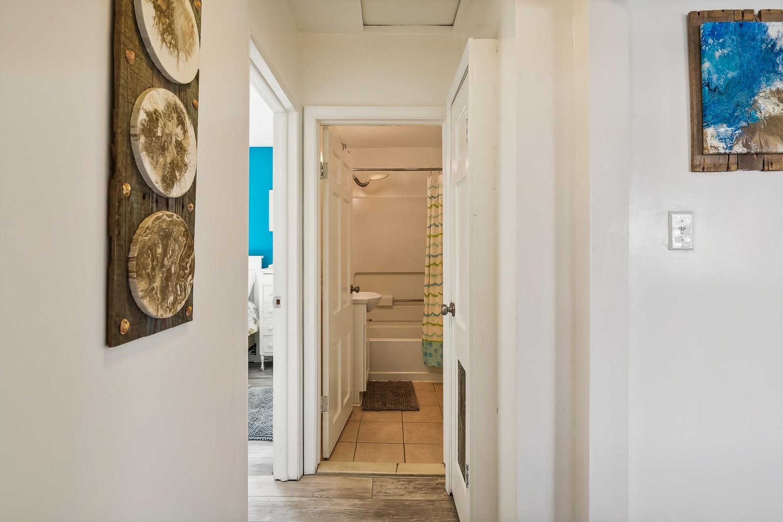 Bright hallways connect your private spaces, with coastal-inspired artwork adding a relaxed, beachy feel throughout your rental home.