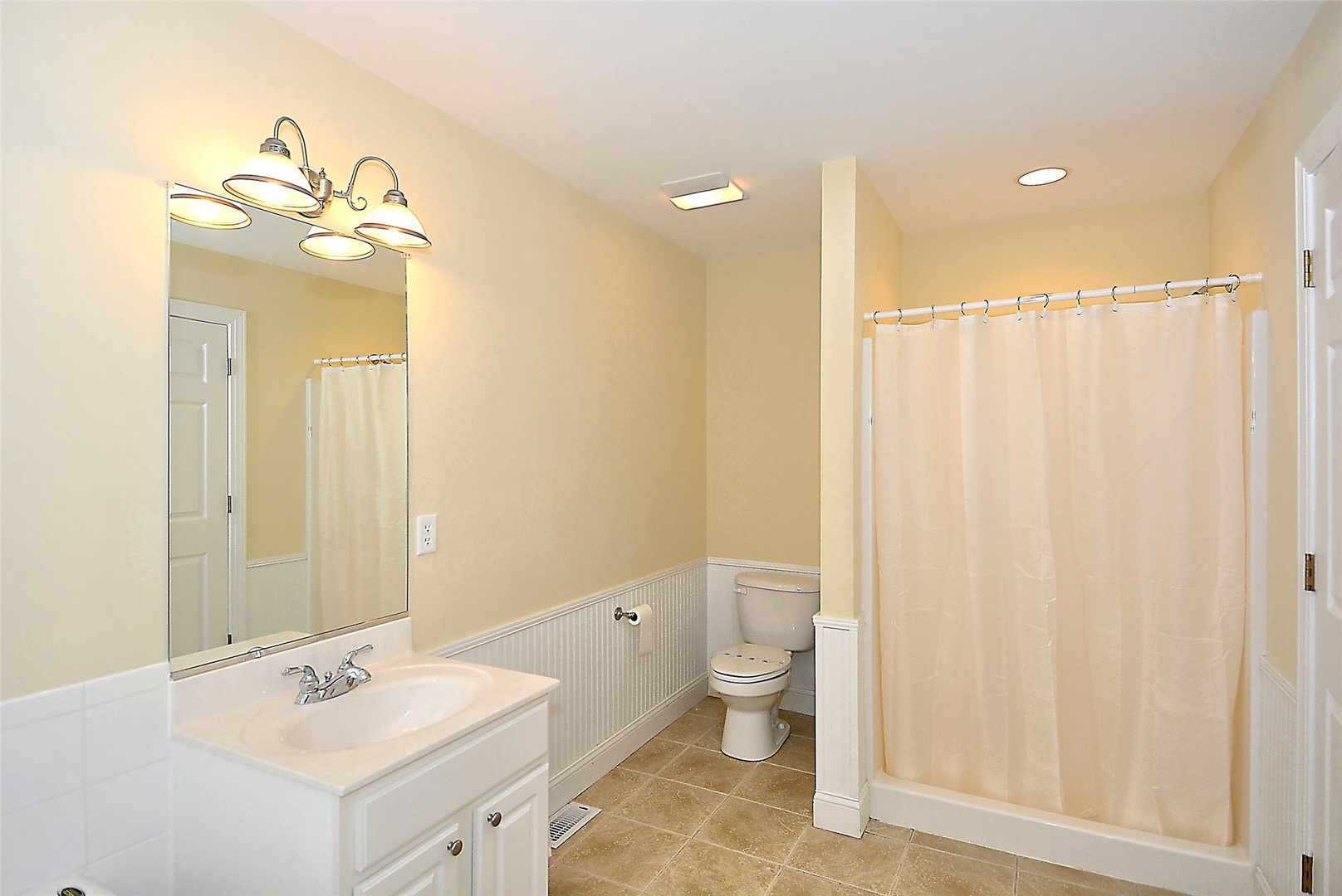 Step into your private sanctuary with soft lighting, warm tones, and a spacious shower-tub combo that invites you to unwind after a day of adventure.