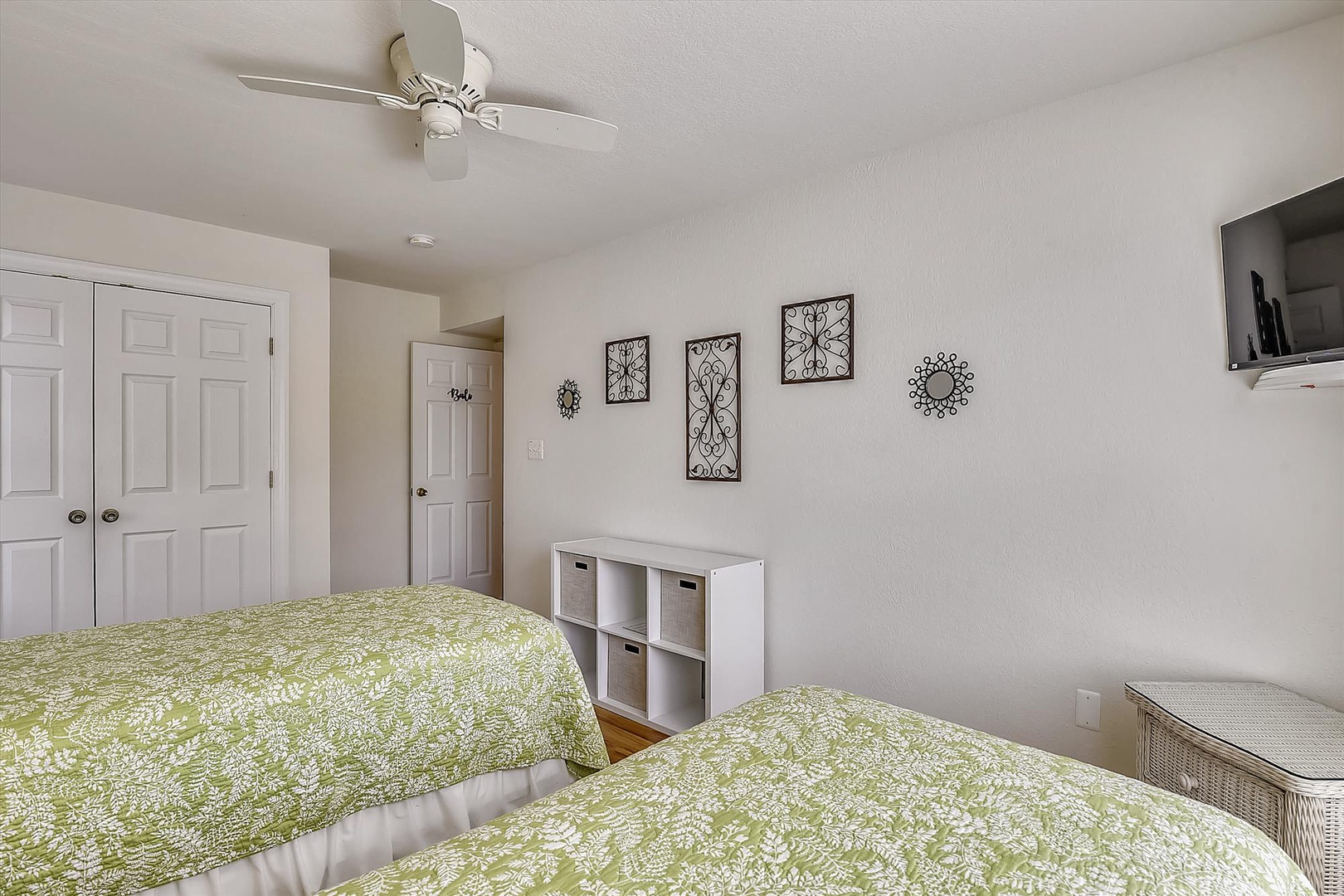 Rest easy in your serene bedroom with fresh linens, gentle ceiling fan breezes, and charming décor welcoming you to unwind after a day of adventure.