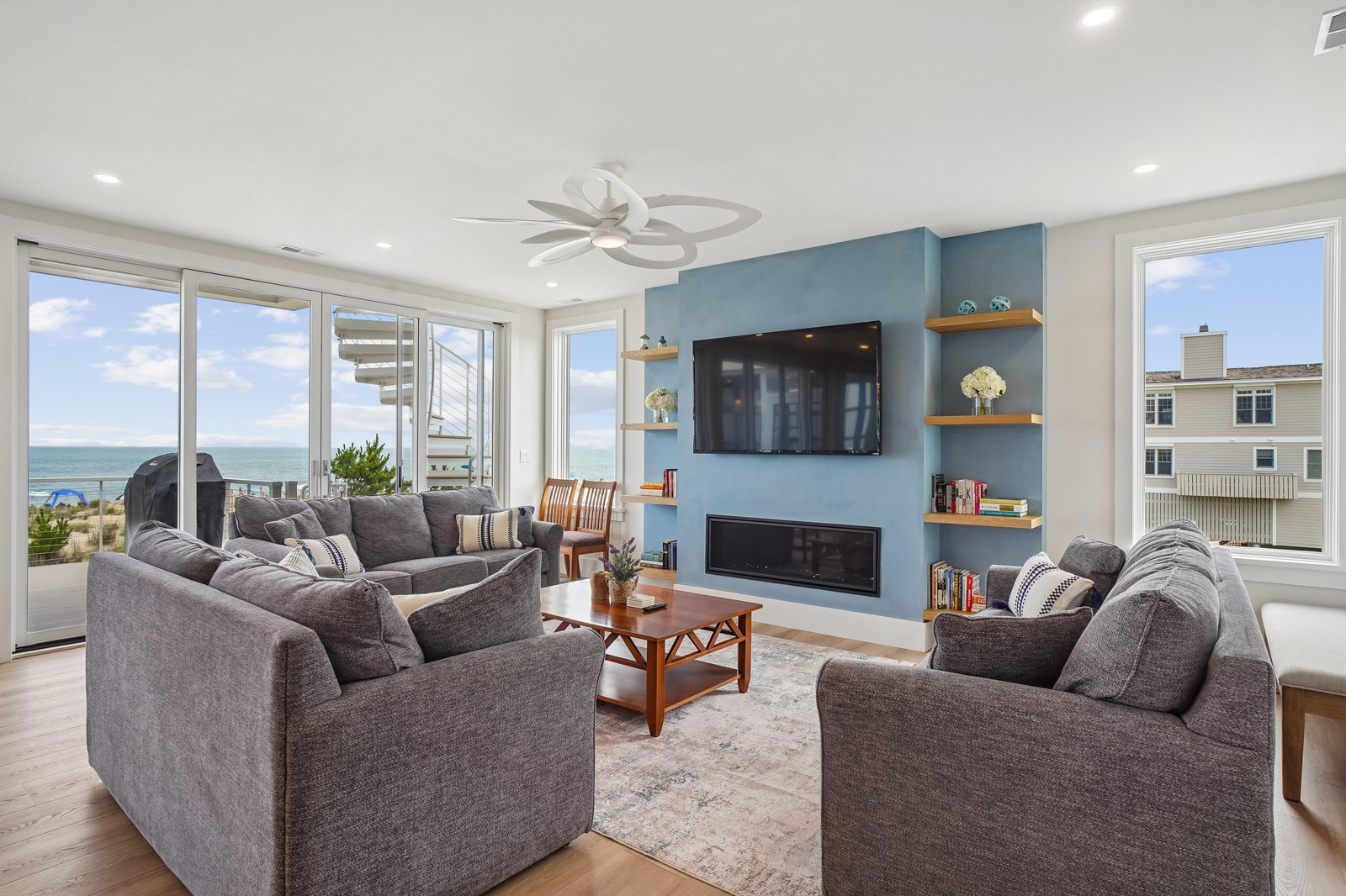 Sink into comfort in your bright living space with stunning ocean views and a cozy fireplace—perfect for unwinding after your beach adventures.