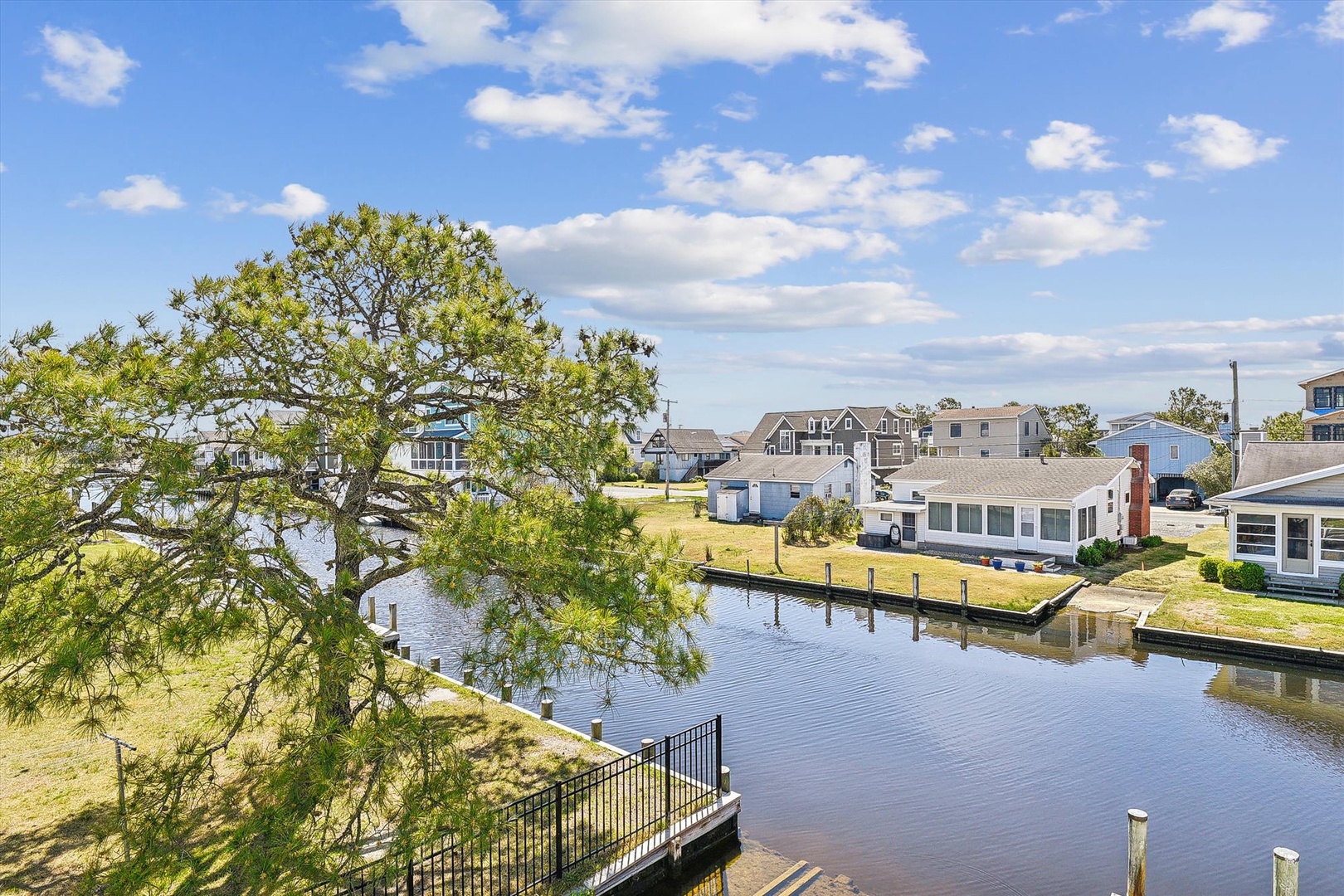 Serene waterfront setting with direct canal access and peaceful neighborhood views, perfect for boating enthusiasts and coastal living.
