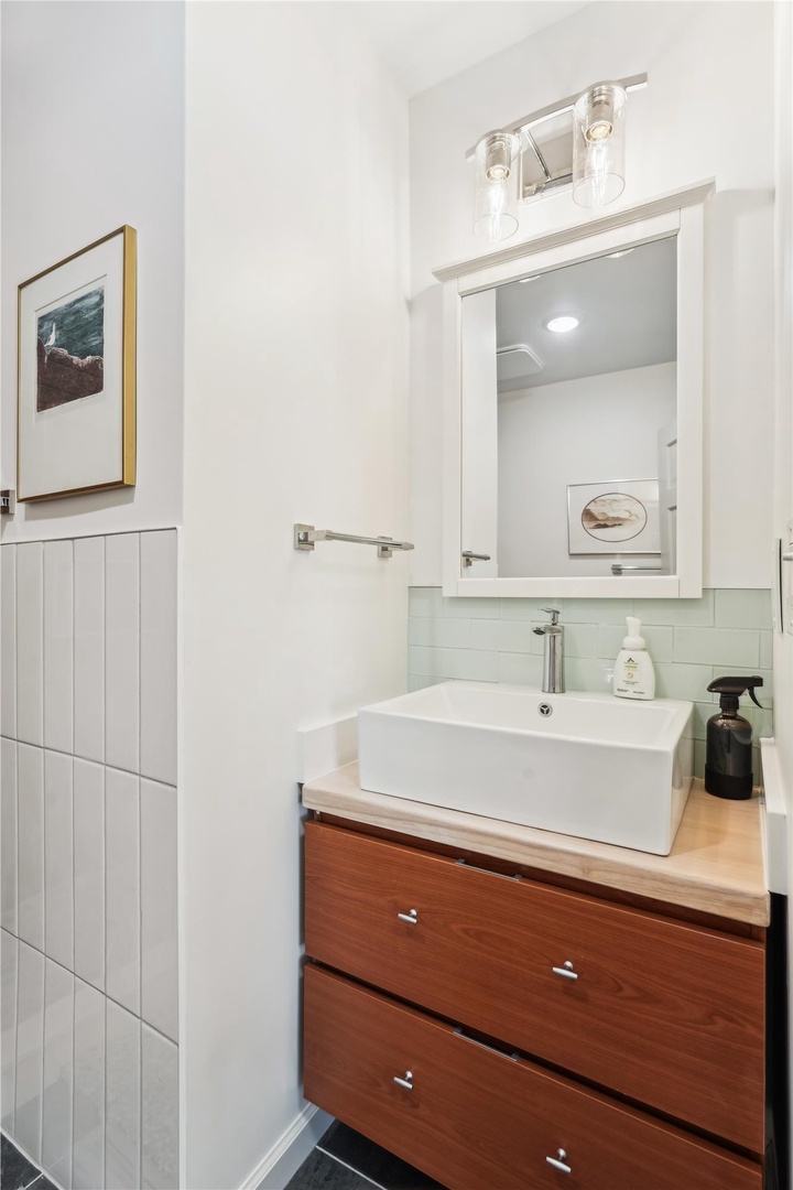 Step into your bright, beautifully designed bathroom with a modern vessel sink, warm wood vanity, and elegant fixtures that make getting ready feel like a treat.