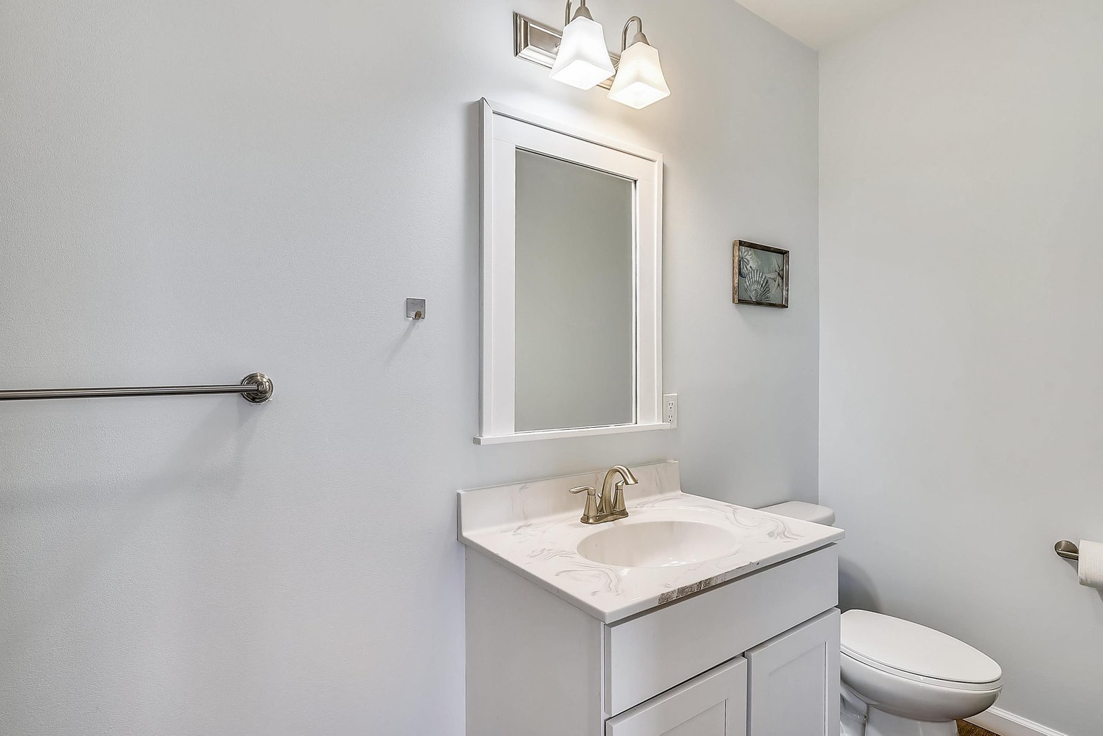 Freshen up in your bright, modern bathroom with a spacious vanity and elegant marble countertop. The soft lighting and clean design create a calm, spa-like atmosphere for your morning routine.