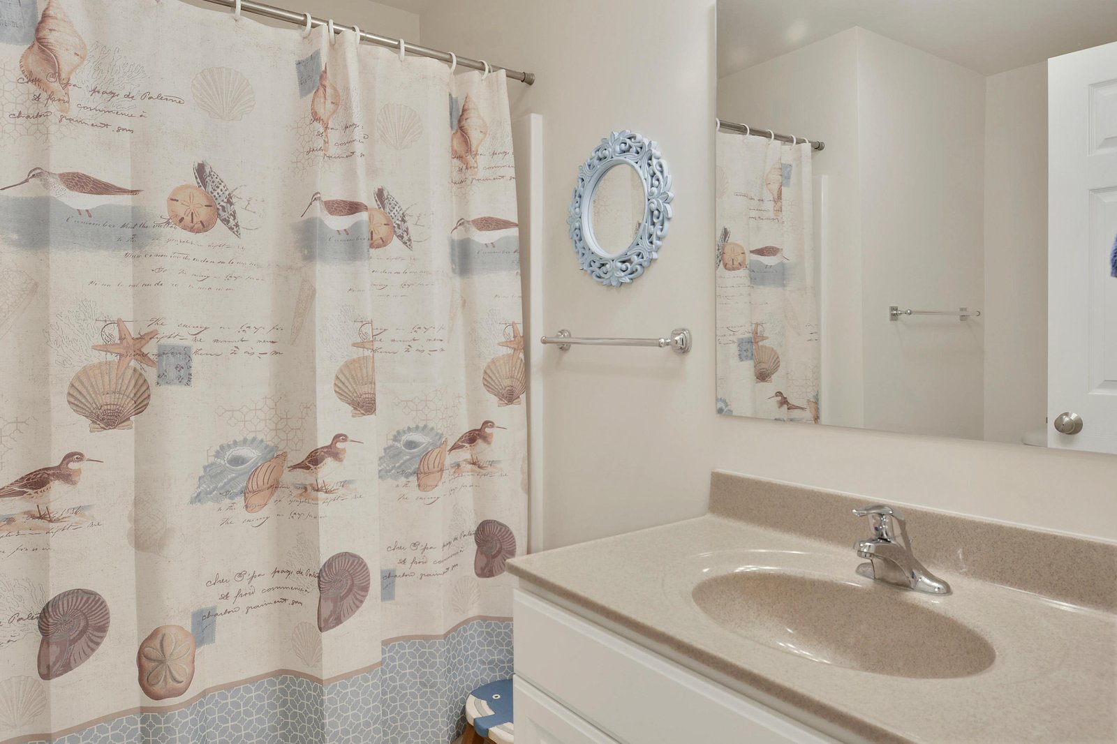 Your private bathroom features a coastal-themed design with cheerful seashell accents and a spacious vanity, making your morning routine feel like a seaside escape.