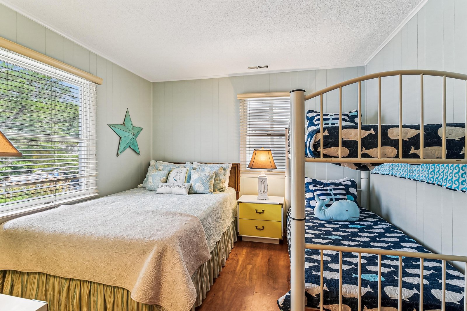 Drift off in this cozy coastal bedroom, where crisp linens and cheerful nautical touches—including a fun bunk bed—create the perfect retreat for your beach getaway.