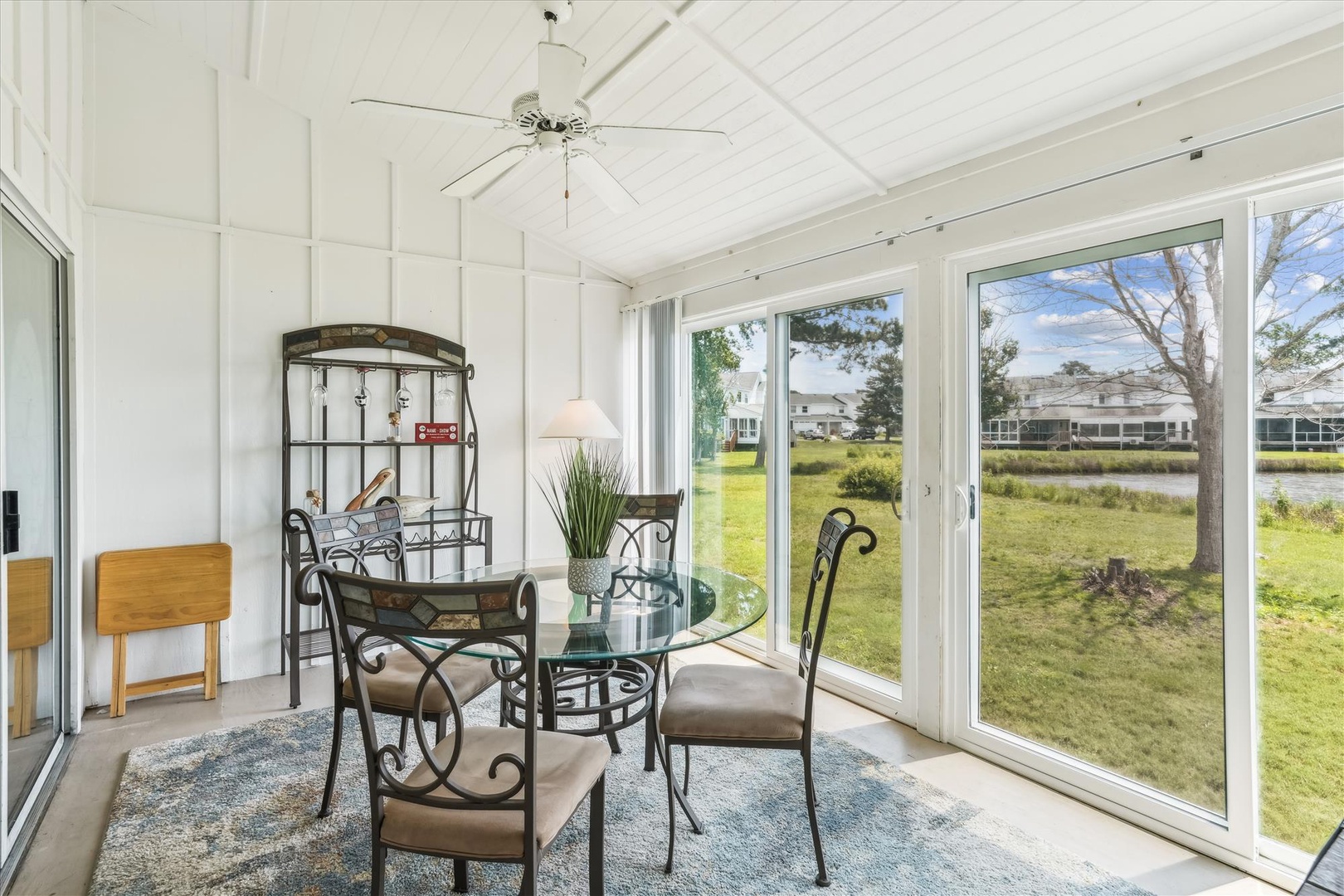 Relax in your bright sunroom with panoramic windows showcasing peaceful golf course views, perfect for morning coffee or evening meals.