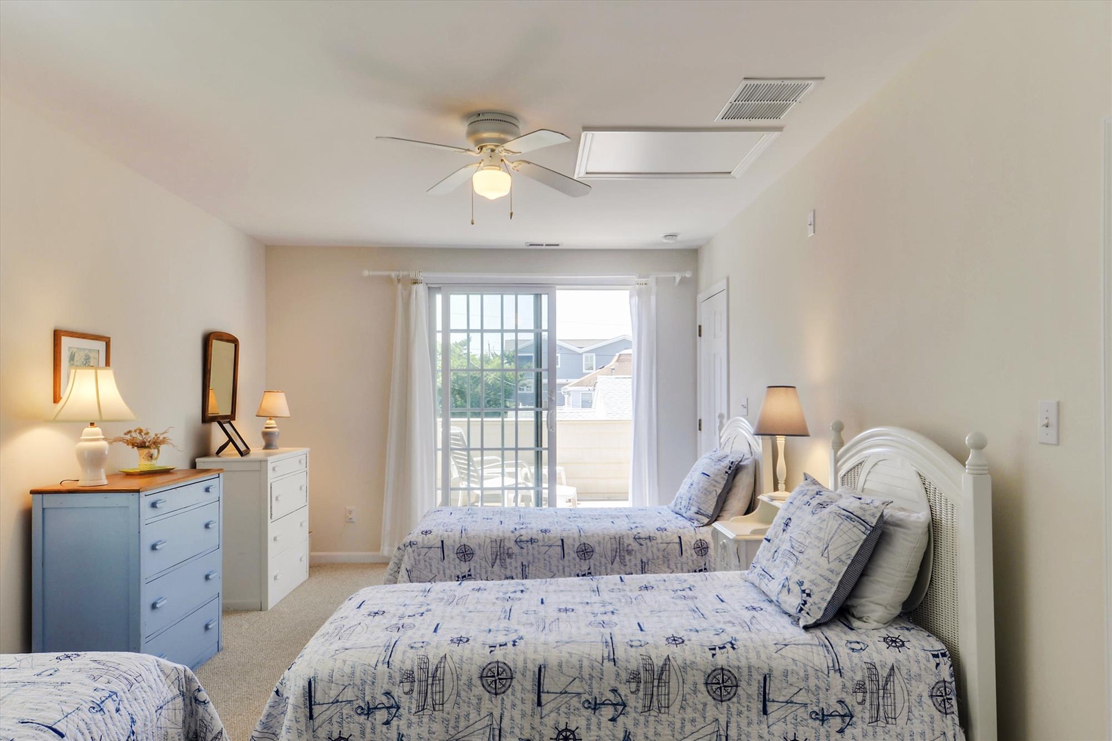 Settle in for the night surrounded by cheerful coastal charm, with three comfortable beds, soft lighting, and a ceiling fan to keep you cool.