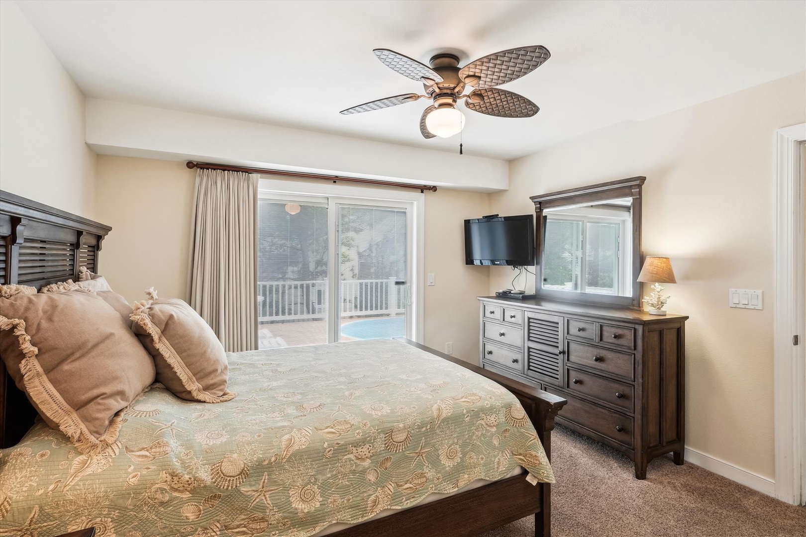 Wake up in your serene bedroom, where plush linens and coastal elegance meet. Step through the sliding doors to your private balcony overlooking the sparkling pool.