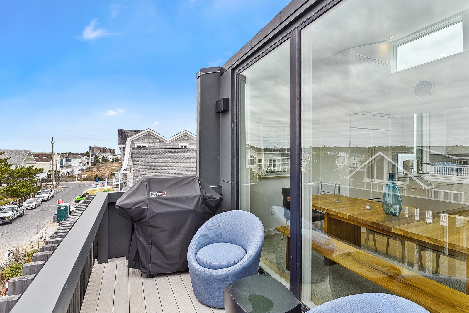 Your private rooftop terrace awaits with a cozy chair and grill, perfect for enjoying warm evenings and neighborhood views.