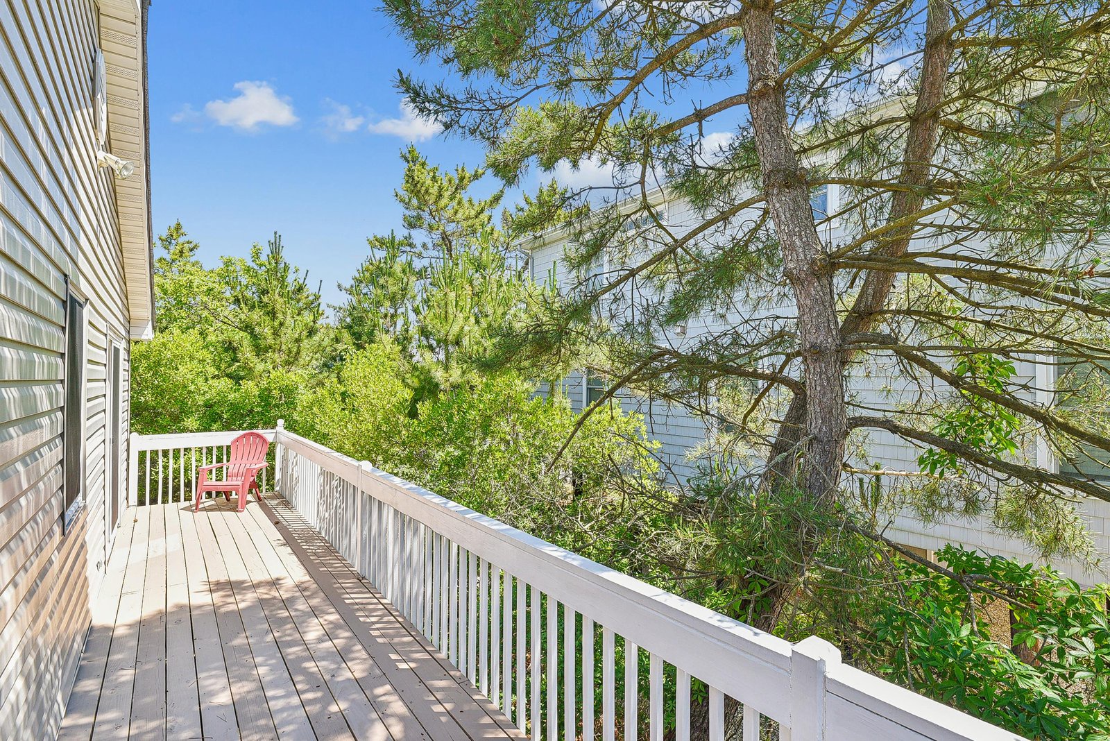 A private deck tucked among the trees, where your morning coffee feels a little more peaceful and the fresh air comes naturally.