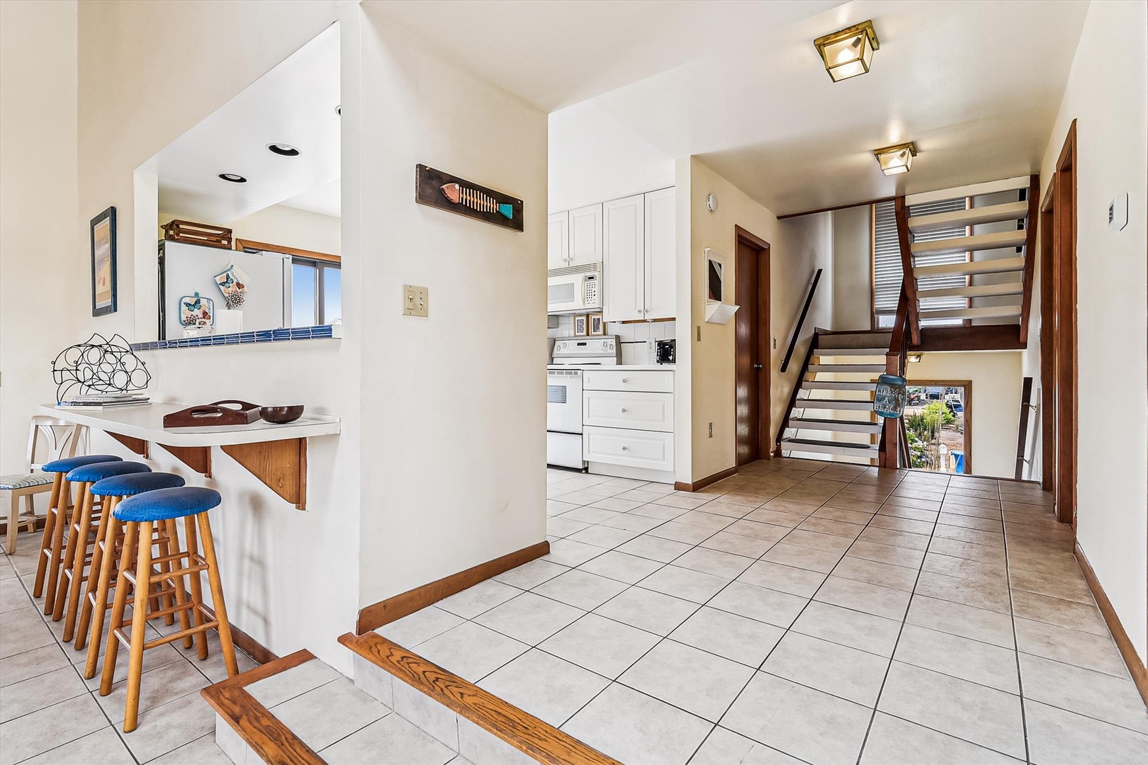 Bright, open layout connects your kitchen, breakfast bar, and stairway—ready to help you feel right at home from the moment you arrive.