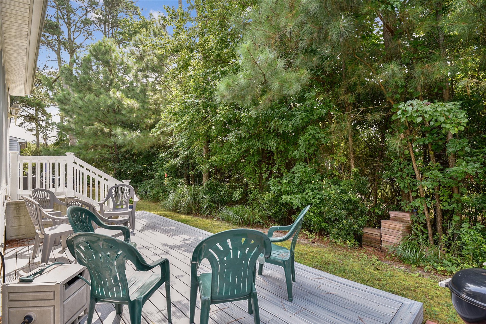 A peaceful wooded setting surrounds your private deck with ample seating for outdoor relaxation, dining, or morning coffee among the pines.