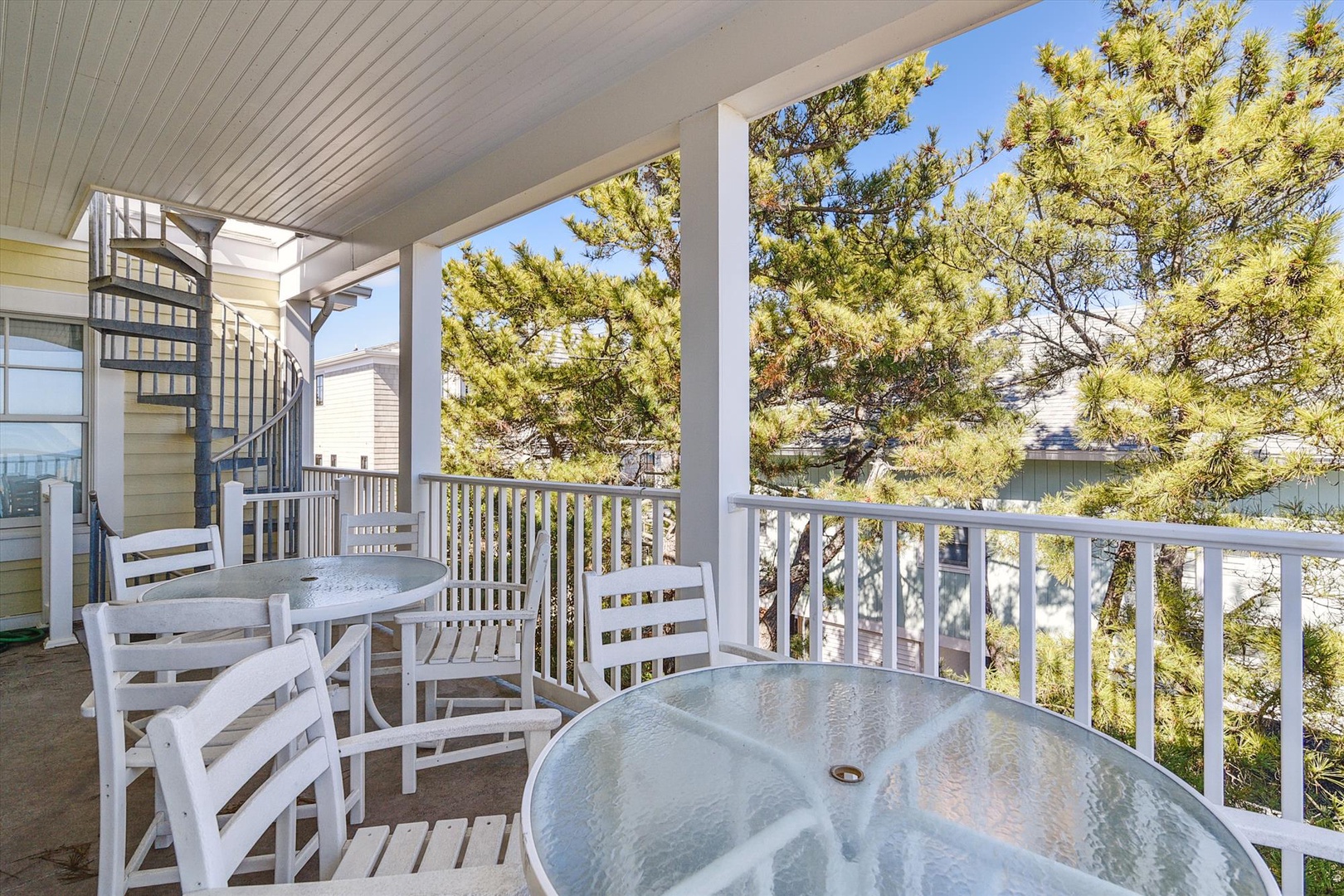 Soak in the hot tub on your covered deck while taking in peaceful views of the surrounding pines and neighborhood. The seating area invites moments of relaxation under open skies.