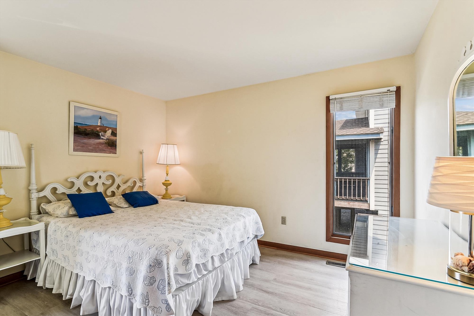 Unwind in your bright, serene bedroom with a plush bed and private balcony access—perfect for morning coffee or evening relaxation after exploring the area.