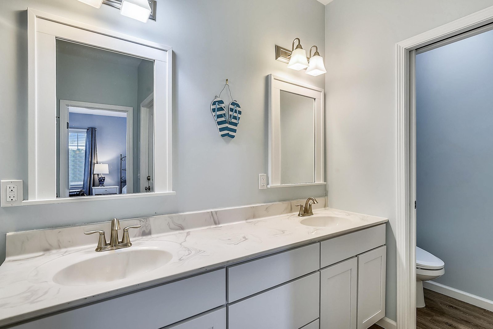 Freshen up in your bright coastal bathroom, complete with a dual vanity and cheerful beach-themed touches that make every morning feel like a getaway.