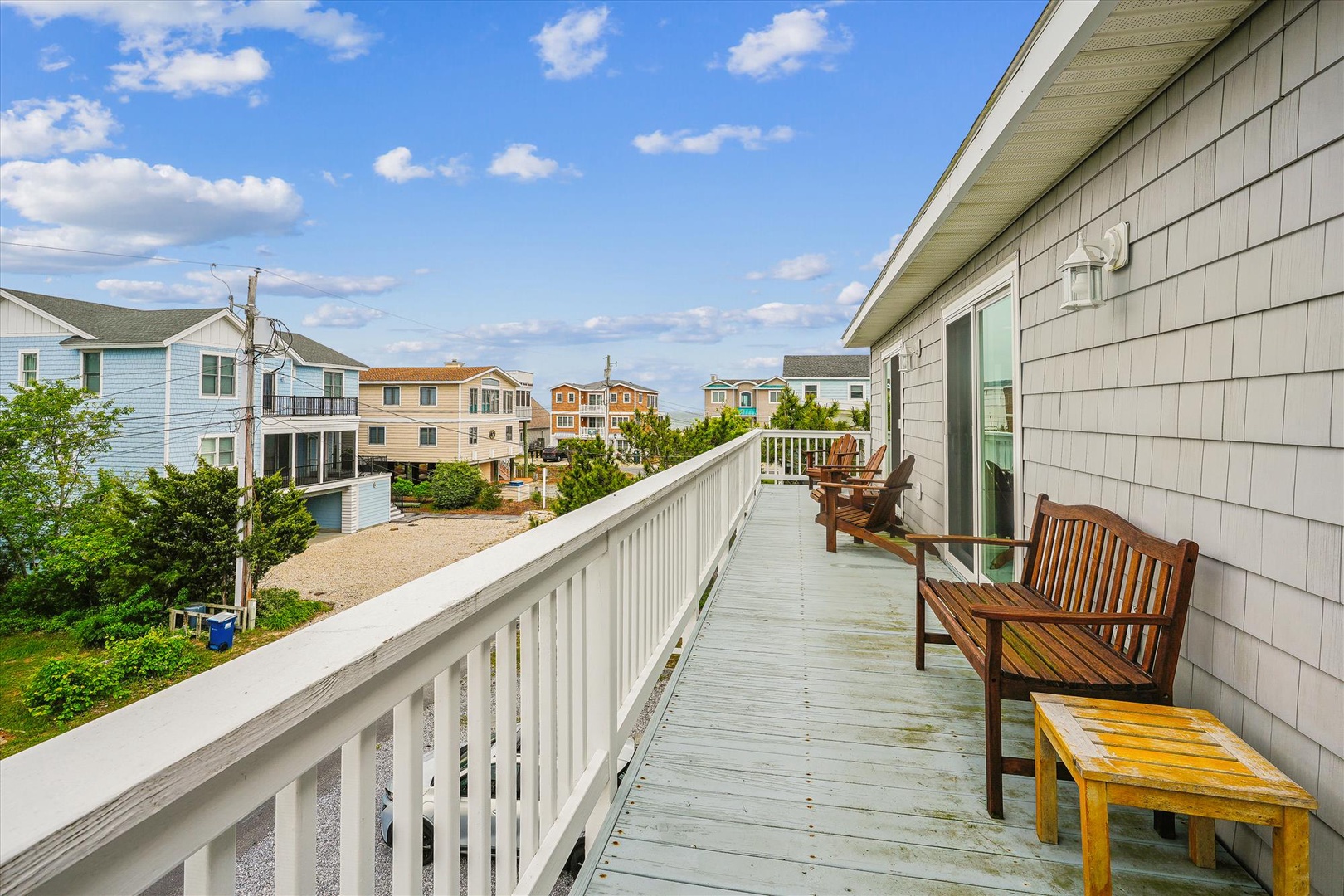 Relax on your private deck with comfortable seating and coastal neighborhood views. The perfect spot to enjoy your morning coffee or evening sunset while feeling the ocean breeze.