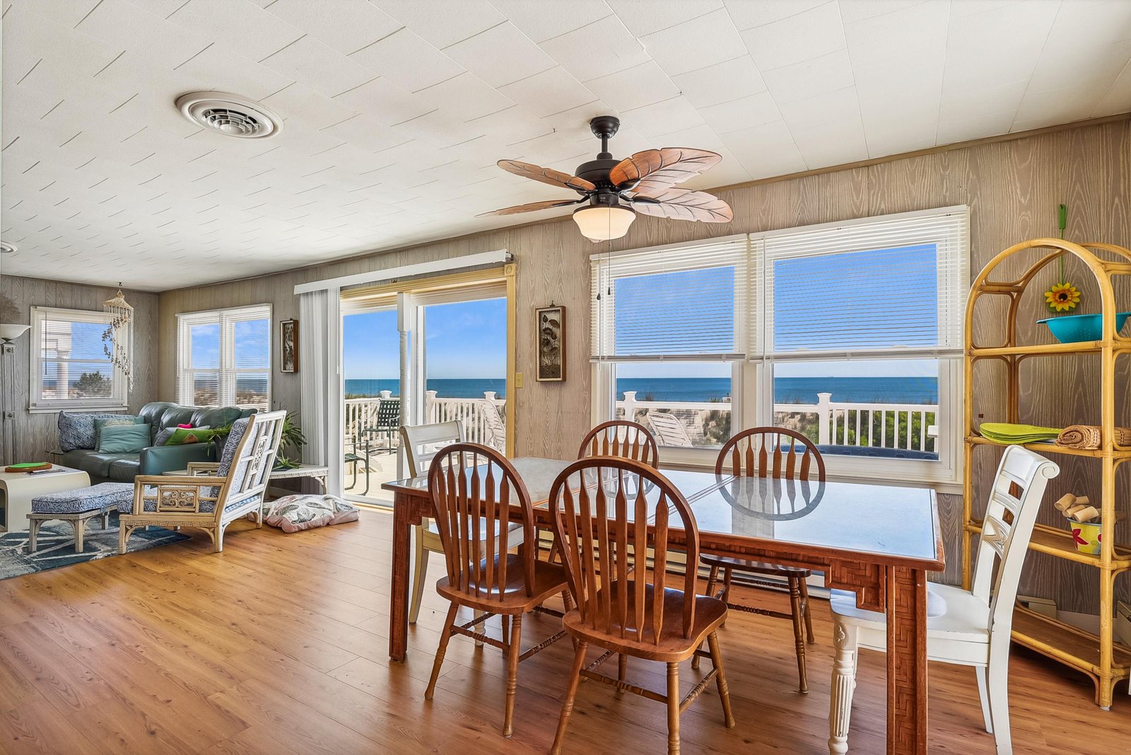 Step into a bright and airy space where ocean waves frame your morning coffee. Large windows invite the sea breeze in, while warm wood floors and coastal charm make this the perfect gathering spot for your beach getaway.