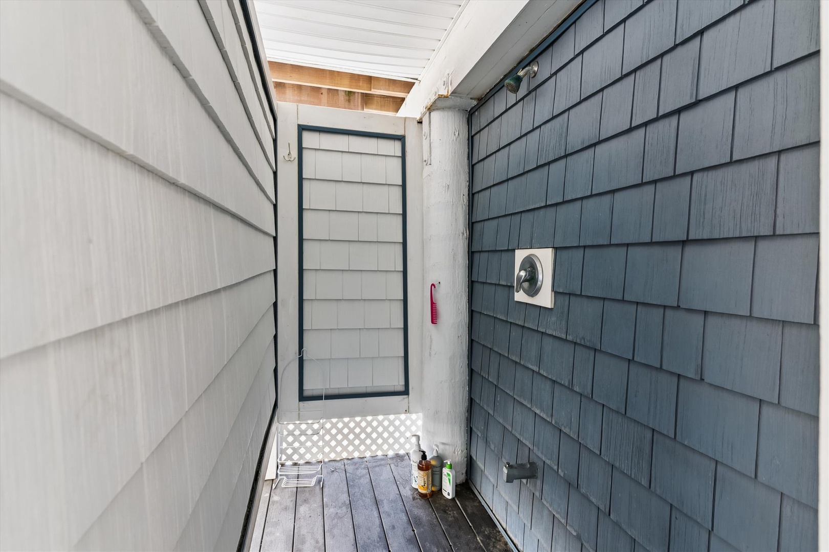 The property features a private outdoor shower area with beach-inspired finishes, providing a convenient space to rinse off after sandy adventures.