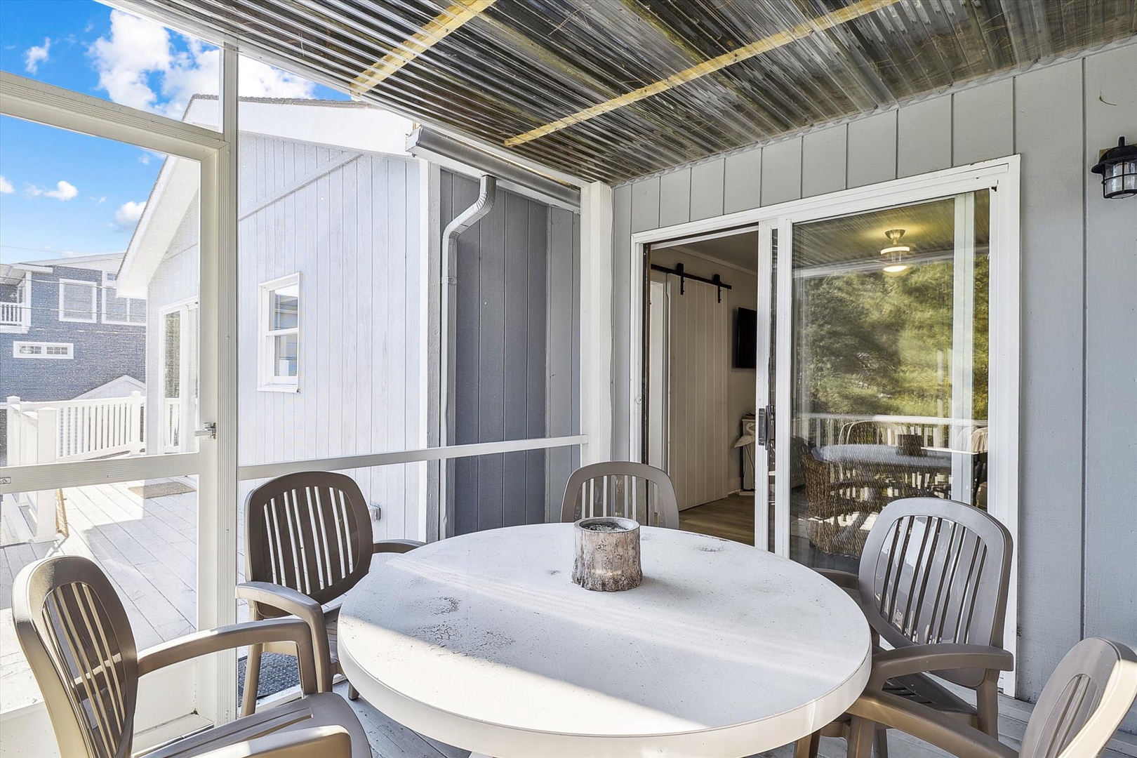 Your private covered patio provides the perfect spot to enjoy morning coffee or evening meals, seamlessly connecting you to the coastal surroundings while offering shade and comfort.