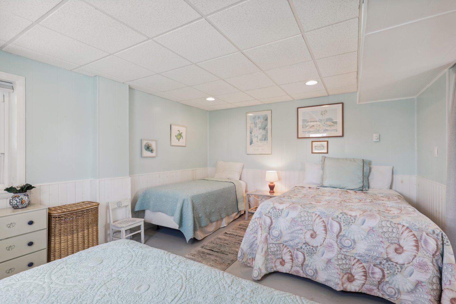 Your bright coastal retreat features two plush beds, soft linens, and soothing pastel tones that invite you to unwind in absolute comfort.