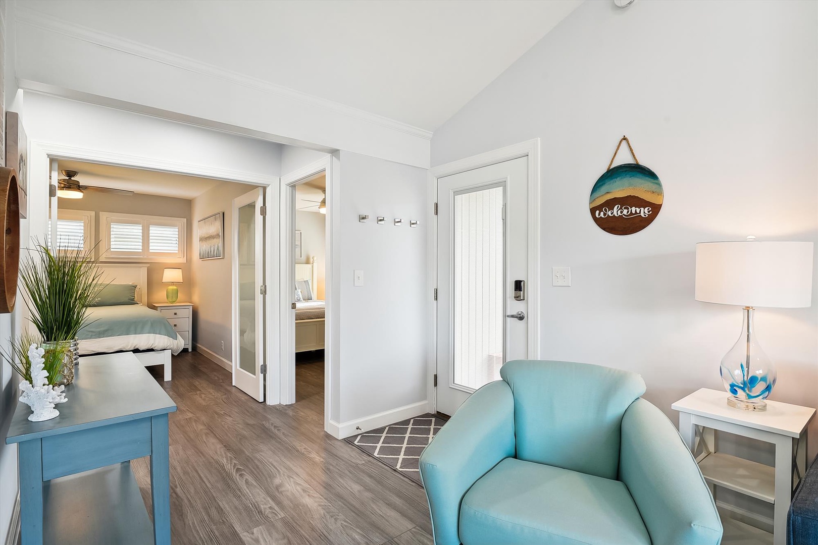 Unwind in your bright, coastal-inspired living space where soft blues meet warm wood tones, creating the perfect spot to relax after exploring.