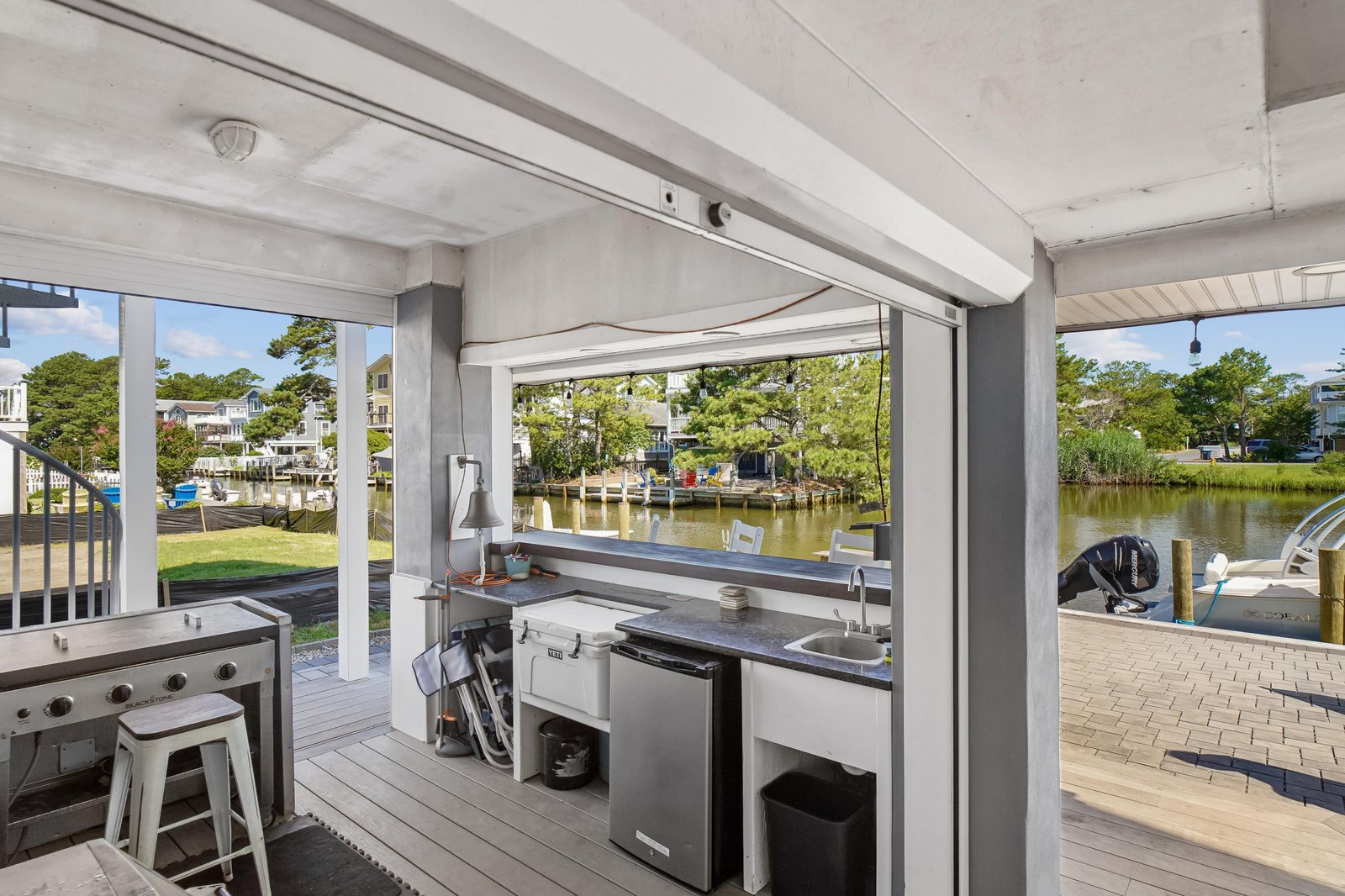 Your private waterfront oasis awaits, featuring a fully equipped outdoor kitchen and stunning river views perfect for entertaining or unwinding by the water.