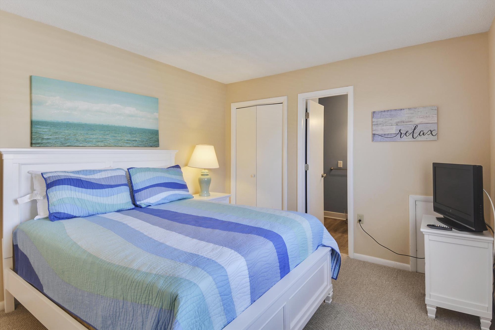Sink into crisp coastal linens and let the ocean artwork set your vacation mood. Your private retreat features comfy sleeping space, entertainment, and plenty of storage for a restful stay.