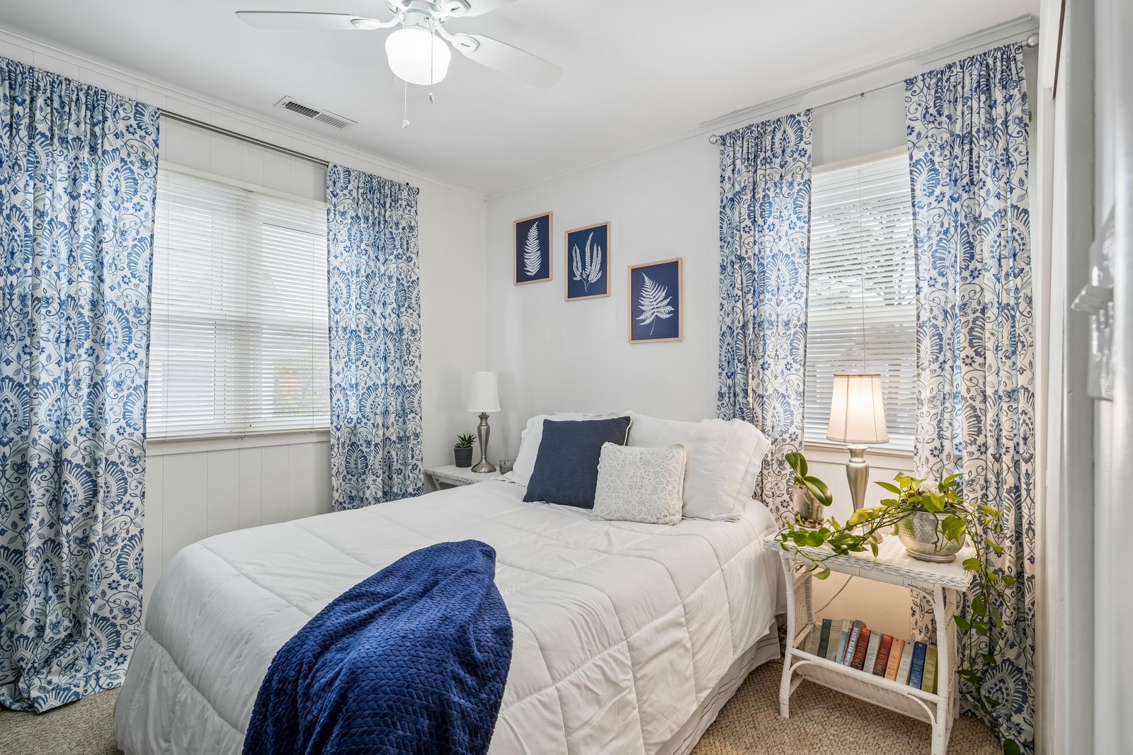 Drift off in your serene coastal-inspired bedroom, where soft linens and botanical artwork create the perfect sanctuary for restful nights and peaceful mornings.