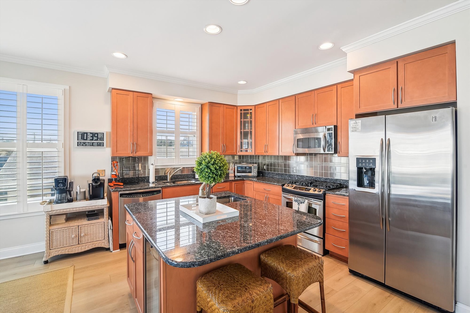 Your spacious, sunlit kitchen awaits with gleaming granite countertops, stainless appliances, and a charming island—perfect for preparing meals and gathering with loved ones.