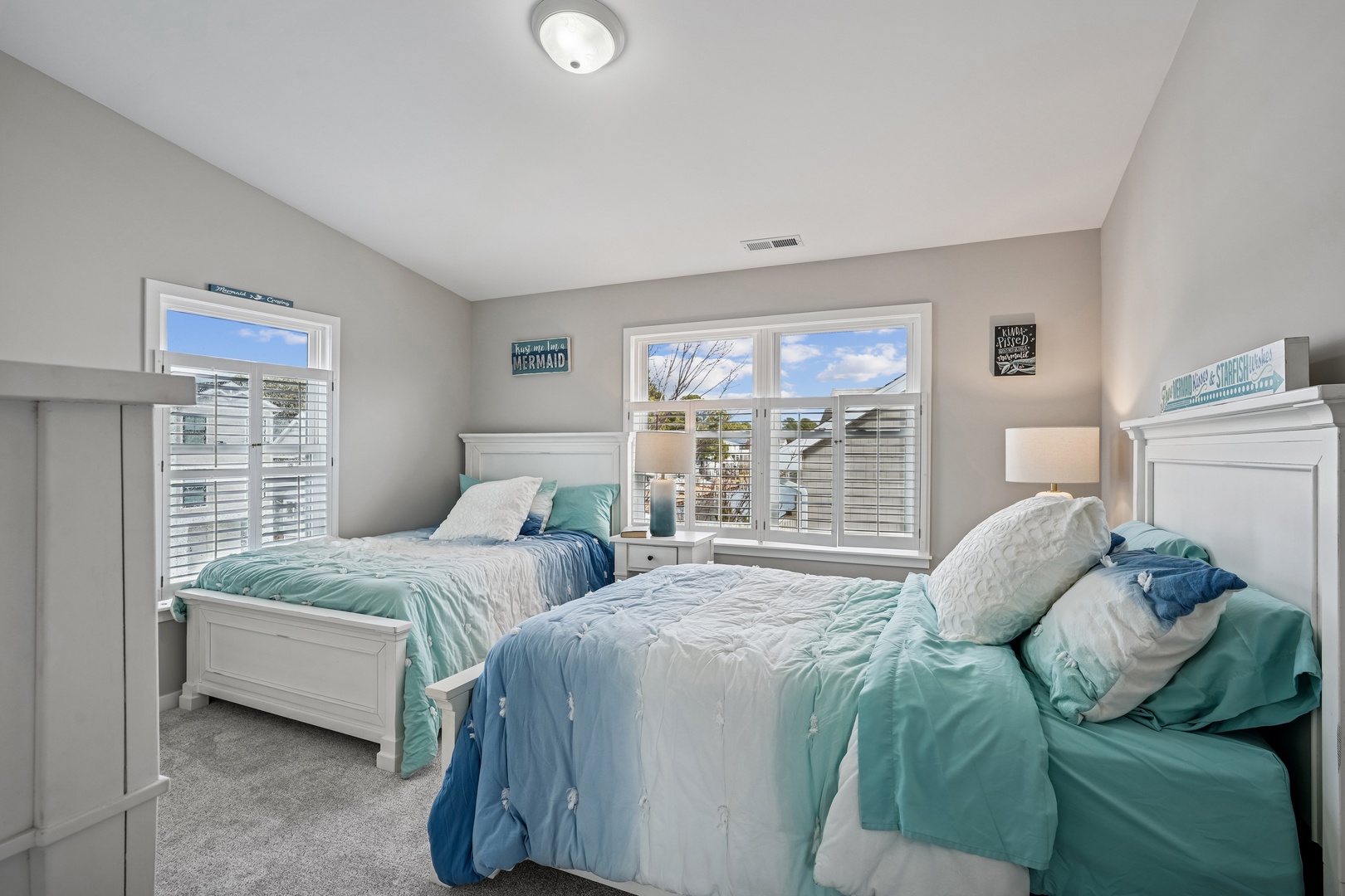 Rest peacefully in your ocean-inspired twin bedroom, where soft blues and whites create a calming coastal retreat for restful nights.