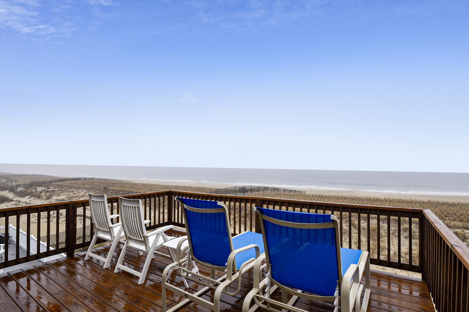 Step out onto your private oceanfront deck and breathe in the salty air. Blue-backed lounge chairs and classic rockers invite you to settle in, coffee in hand, as the waves roll in just beyond the dunes.